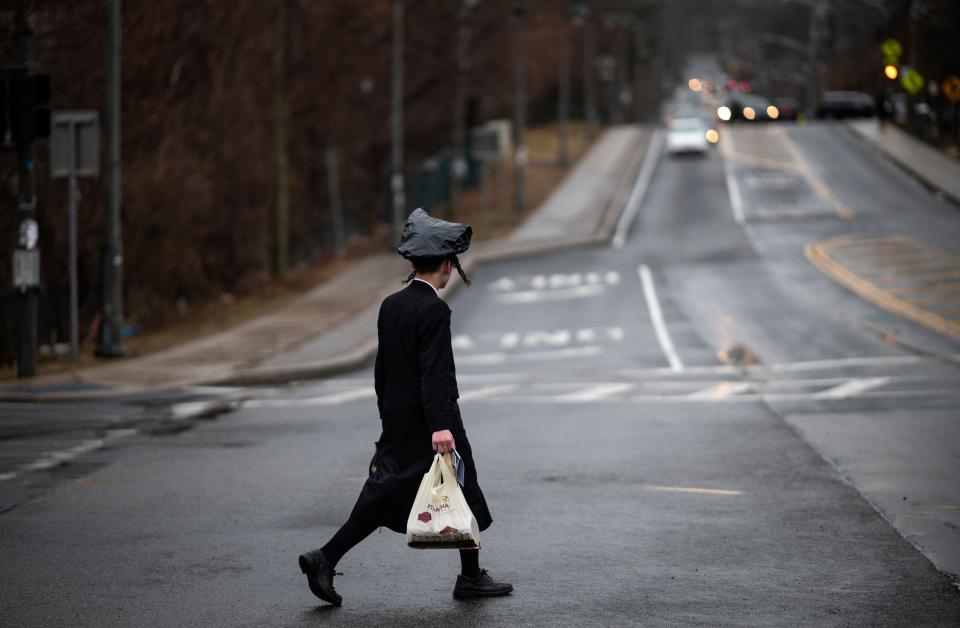 A youth crosses a street in Monsey, New York, where a measles outbreak has sickened scores of people, mainly from the Orthodox Jewish community. (Photo: JOHANNES EISELE via Getty Images)