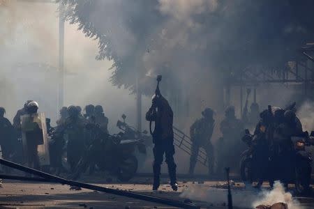 Riot police fire tear gas at opposition supporters during a rally against Venezuela's President Nicolas Maduro in Caracas, Venezuela May 20, 2017. REUTERS/Carlos Barria