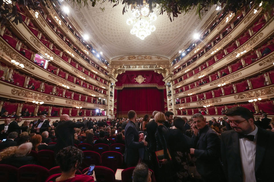 Spectators arrive to attend La Scala opera house's gala season opener, Giuseppe Verdi's opera 'Don Carlo' at the Milan La Scala theater, Italy, Thursday Dec. 7, 2023. The season-opener Thursday, held each year on the Milan feast day St. Ambrose, is considered one of the highlights of the European cultural calendar. (AP Photo/Luca Bruno)