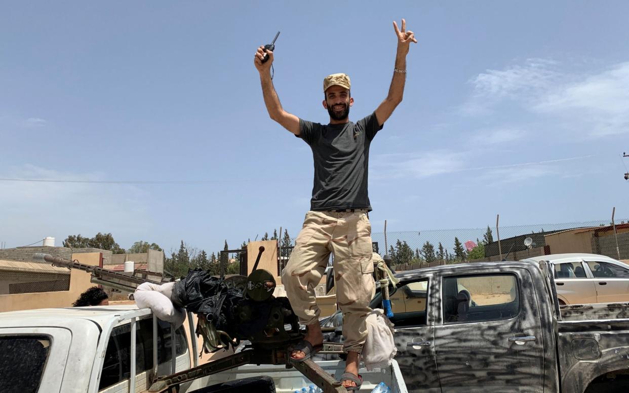 A fighter loyal to the GNA celebrates after victory in a battle for the capital - Reuters