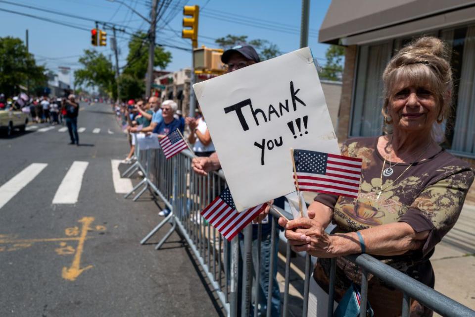 A woman holds a sign at the 104th annual Memorial Day parade on Monday in the Staten Island borough of New York City.