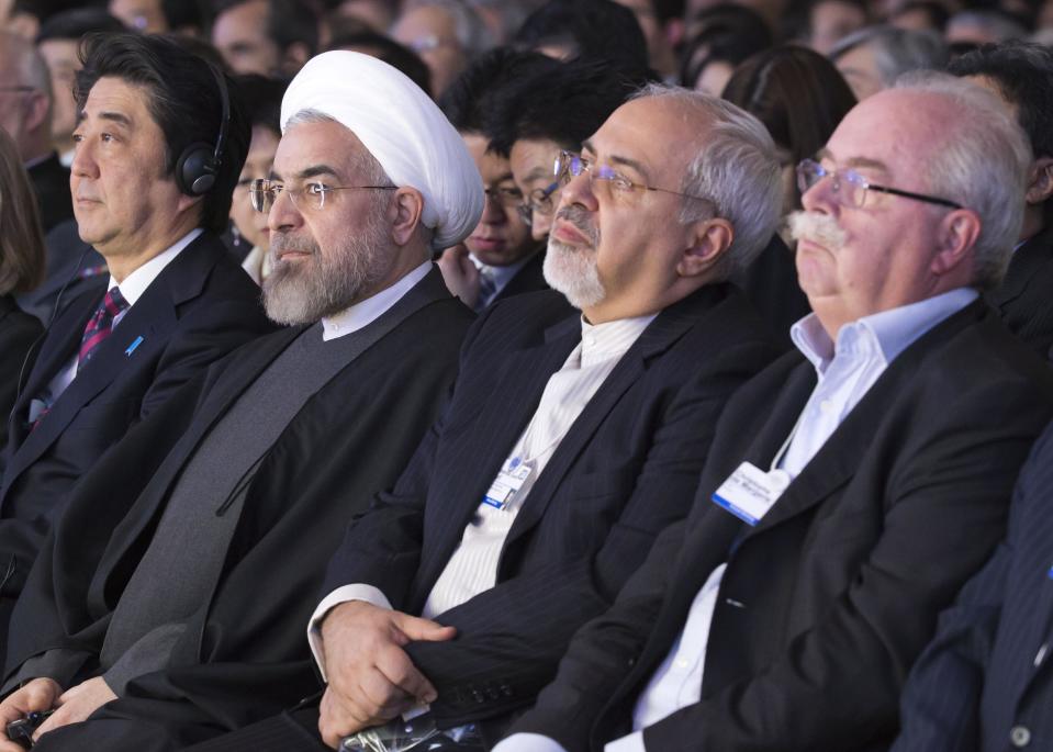 From left, Japanese prime minister Shinzo Abe, Iranian President Hassan Rouhani, Iranian Foreign Minister Mohammad Javad Zarif and CEO of Total, Christophe de Margerie, attend a session of the World Economic Forum in Davos, Switzerland, Wednesday, Jan. 22, 2014. Leaders gathered in the Swiss ski resort of Davos have made it a top priority to push to reshape the global economy and cut global warming by shifting to cleaner energy sources. (AP Photo/Michel Euler)