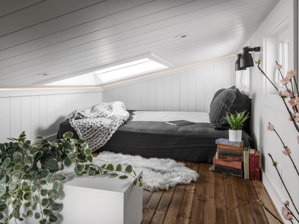 a lofted bedroom with a bed on the ground