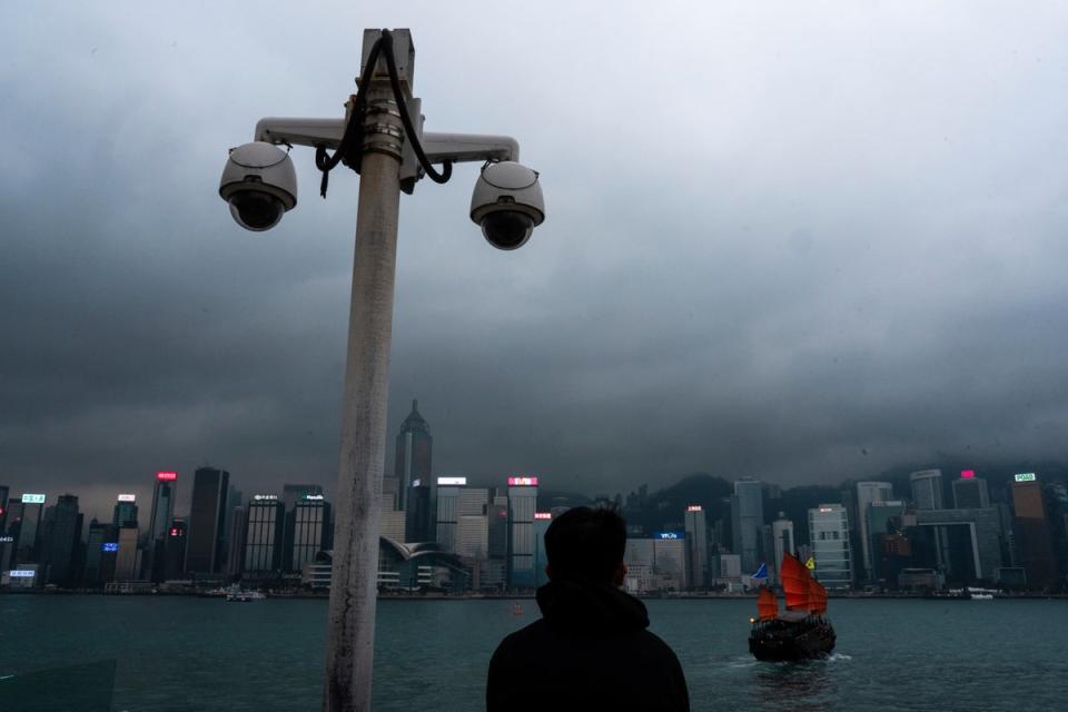 File: Surveillance cameras are seen as a visitor looks at Victoria Harbour in Hong Kong on 11 March 2024 (AP)