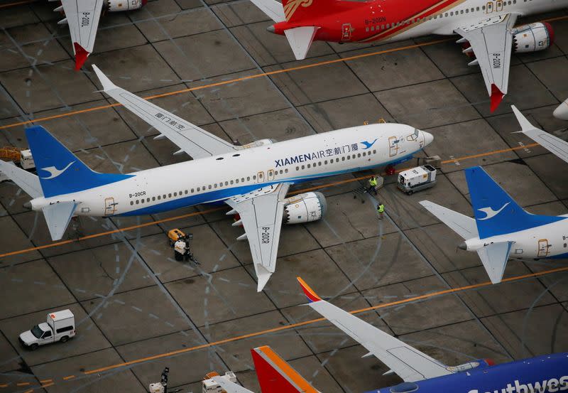 Workers move around a Xiamen Airlines Boeing 737 MAX aircraft at Boeing facilities at Grant County International Airport in Moses Lake