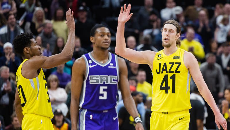 Utah Jazz forward Kelly Olynyk high-fives teammate Ochai Agbaji as Sacramento guard De’Aaron Fox walks away after the Jazz beat the Kings at Vivint Arena in Salt Lake City on March 20, 2023. 