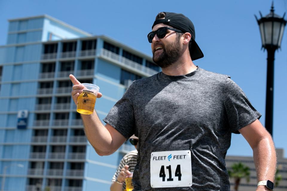 A runner nears the finish line at the 1/2K by the Bay Beer Run at the Corpus Christi Beer Festival in downtown Corpus Christi on Saturday, June 3, 2023.