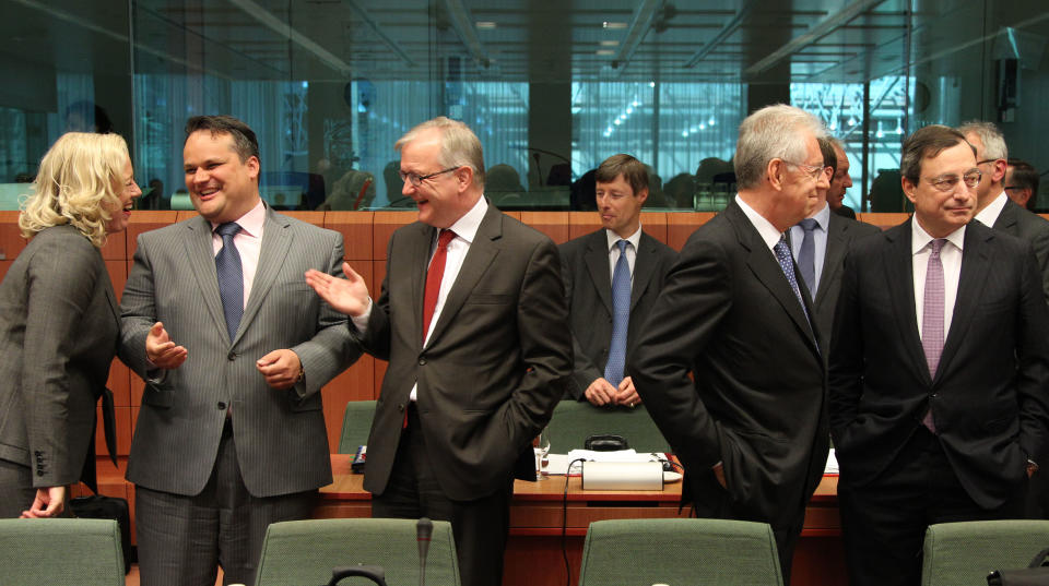 President of the European Central Bank Mario Draghi, right, talks with Italy's Prime and Finance Minister Mario Monti, second right, as European Commissioner for Economic and Monetary Affairs Olli Rehn, center, talks with Dutch Finance Minister Jan Kees De Jager, second left, and Finnish Finance Minister Jutta Urpilainen, during the Eurogroup ministerial meeting at the European Council building in Brussels, Monday, May 14, 2012. (AP Photo / Yves Logghe)