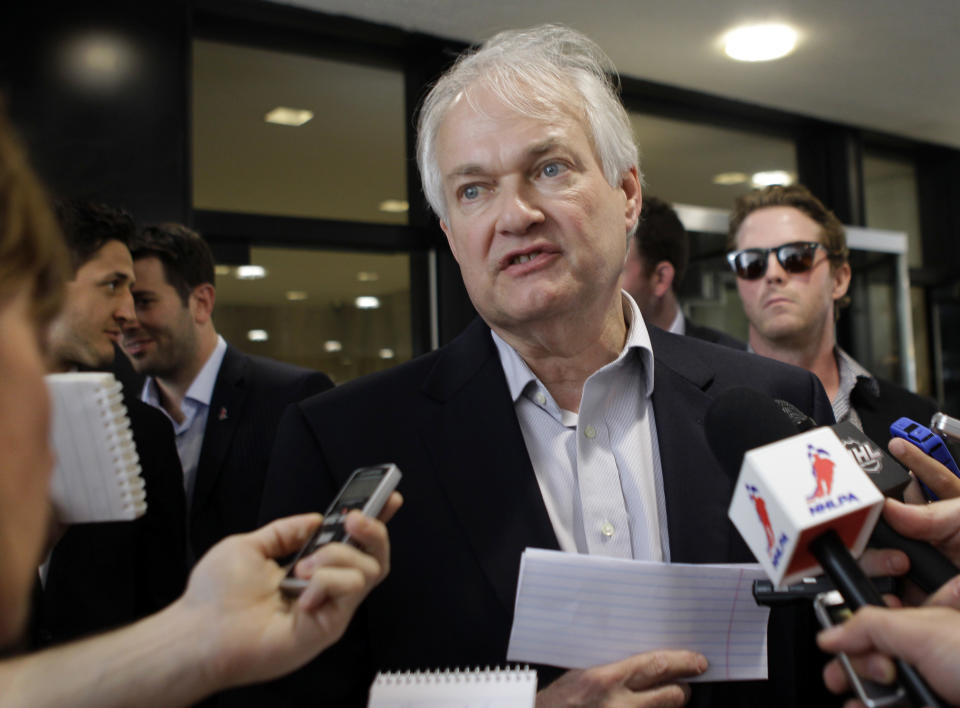 Donald Fehr, executive director of the NHL Players Association, speaks to reporters about on going labor talks with the league outside the NHL headquarters in New York, Tuesday, July 31, 2012. The current collective bargaining agreement ends on Sept. 15, and the NHL season is scheduled to open on Oct. 11. Detroit Red Wings Dan Cleary listens, right.(AP Photo/Kathy Willens)