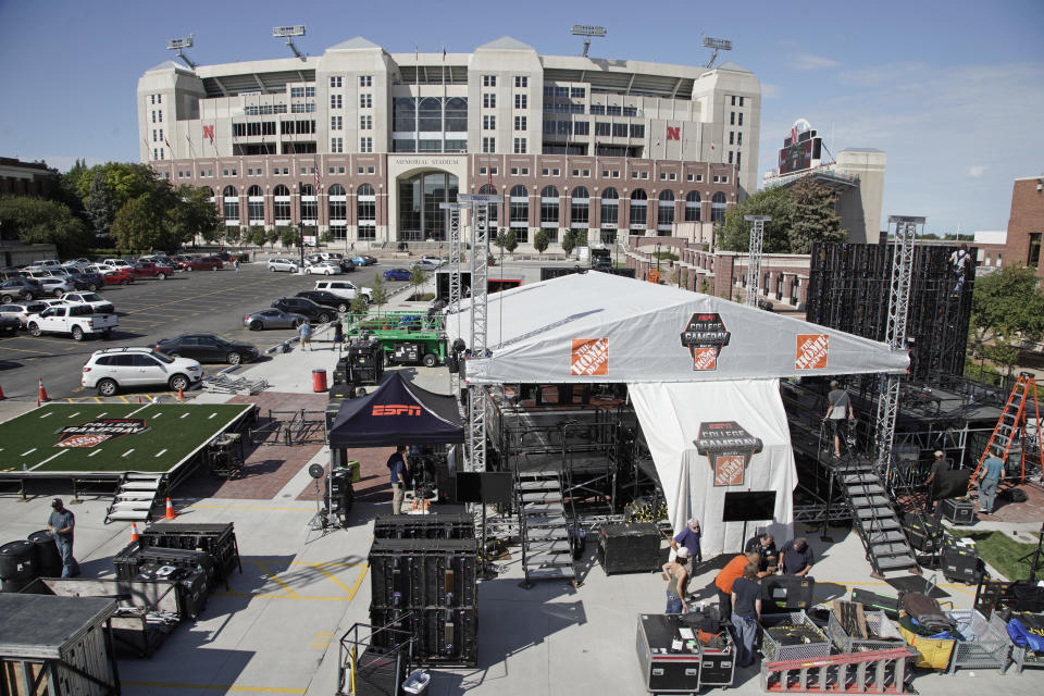 Workers set up the ESPN College GameDay stage in front of Memorial Stadium in Lincoln, Neb., Thursday, Sept. 26, 2019. Nebraska's NCAA college football game against No. 5 Ohio State on Saturday night was always going to be a big one. Add a visit from ESPN's "College GameDay" show in the morning, and it becomes huge. (AP Photo/Nati Harnik)