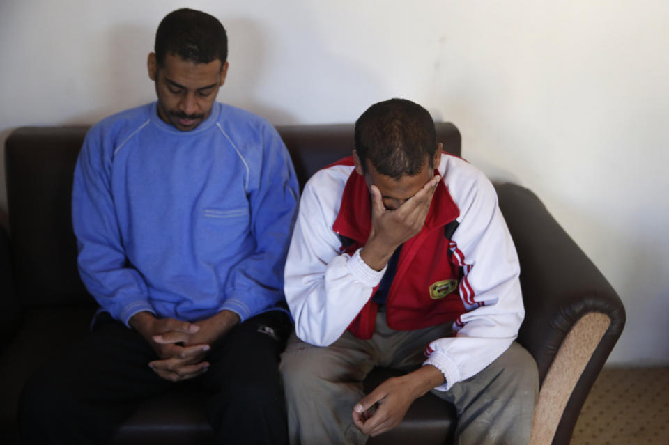 FILE - In this March 30, 2019, file photo, Alexanda Amon Kotey, left, and El Shafee Elsheikh, who were allegedly among four British jihadis who made up a brutal Islamic State cell dubbed "The Beatles," speak during an interview with The Associated Press at a security center in Kobani, Syria. The Justice Department is preparing to announce charges Wednesday against two men from Britain who joined the Islamic State and were part of a cell that beheaded Western hostages, a law enforcement official said. Their arrival in the U.S. to face charges sets the stage for arguably the most sensational terrorism prosecution since the 2014 case against the suspected ringleader of a deadly attack on the diplomatic compound in Benghazi, Libya.(AP Photo/Hussein Malla, File)