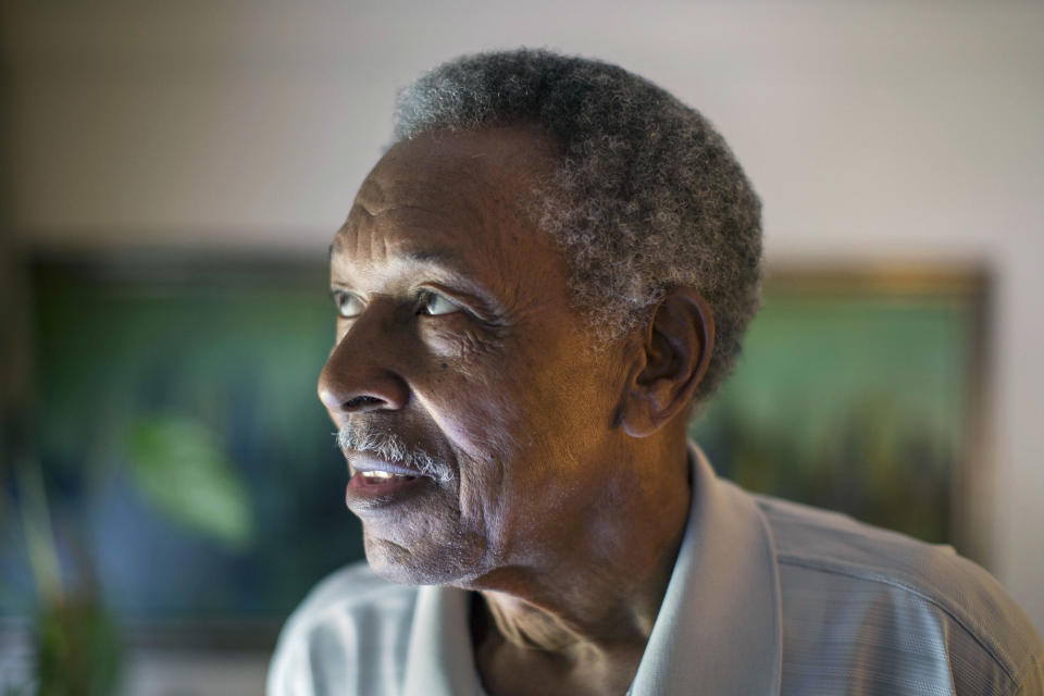 In this June 20, 2013 photo, Otis McDonald, 79, looks out the window of his home on Chicago's South Side. McDonald, who was the lead plaintiff in the lawsuit that led the U.S. Supreme Court to overturn the Chicago's handgun ban has died. McDonald's death on Friday, April 4, 2014, was confirmed Sunday by his nephew and family spokesman, Fred Jones. McDonald was one of four plaintiffs who challenged the city's decades-old handgun ban and who won a 5-4 decision in 2010. He argued that he was trying to protect himself and his family from the violence outside his front door in a deteriorating neighborhood on Chicago's South Side. (AP Photo/Scott Eisen)