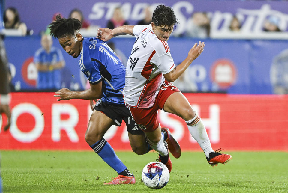CF Montreal's Nathan-Dylan Saliba, left, defends against New England Revolution's Ian Harkes during the second half of an MLS soccer match Saturday, Aug. 26, 2023, in Montreal. (Graham Hughes/The Canadian Press via AP)