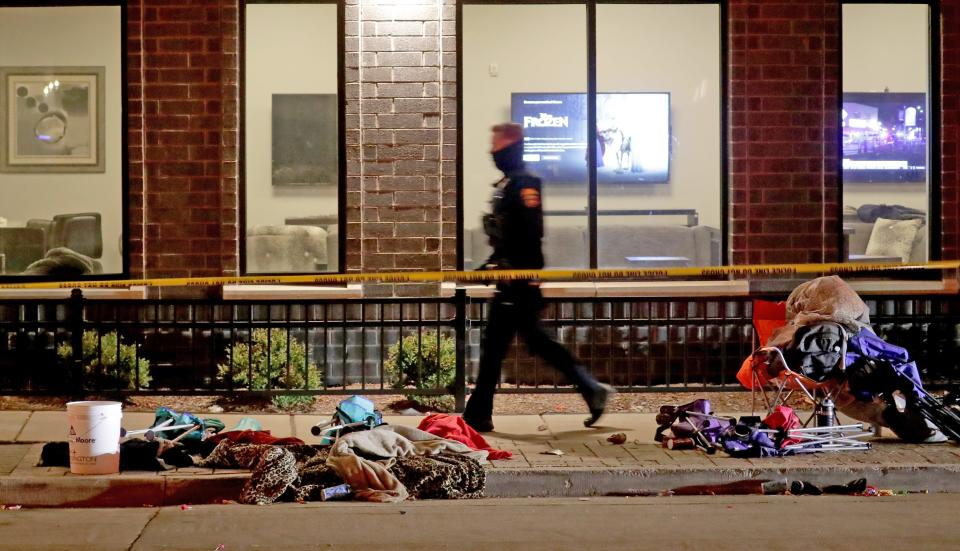 Police investigate at the scene of a crash involving multiple people and injuries at a holiday parade in Waukesha on Sunday, Nov. 21, 2021.