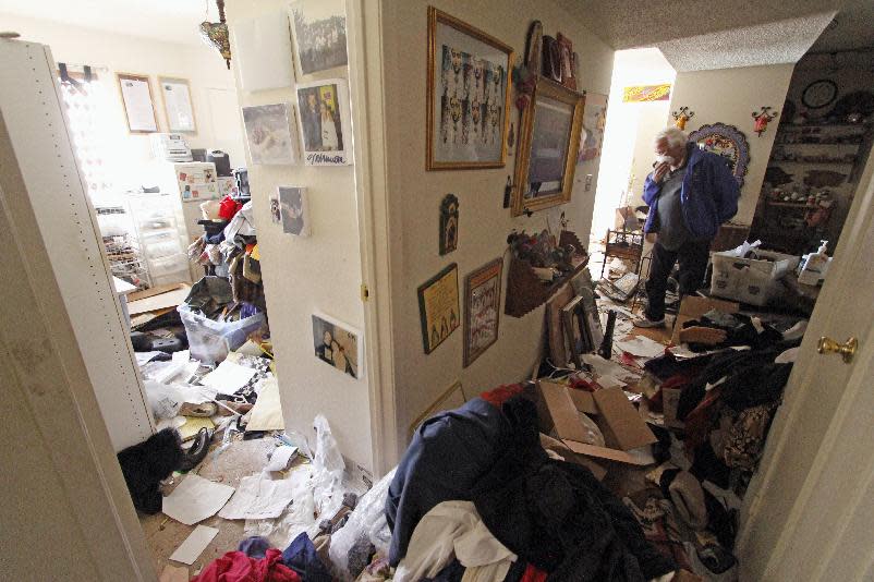 Louis Ponce, brother-in-law of Bobbi Salinas-Norman, walks through the apartment on May 10, 2013, where Salinas-Norman was found dead. Ponce discovered The remains of Salinas-Norman, a Chicana activist, teacher and author, last week and authorities say she may have been dead for more than a year. (AP Photo/The Santa Fe New Mexican,Luis Sanchez Saturno)