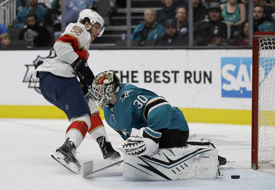 Florida Panthers' Mike Hoffman, left, scores a goal against San Jose Sharks' Aaron Dell (30) during the second period of an NHL hockey game Monday, Feb. 17, 2020, in San Jose, Calif. (AP Photo/Ben Margot)
