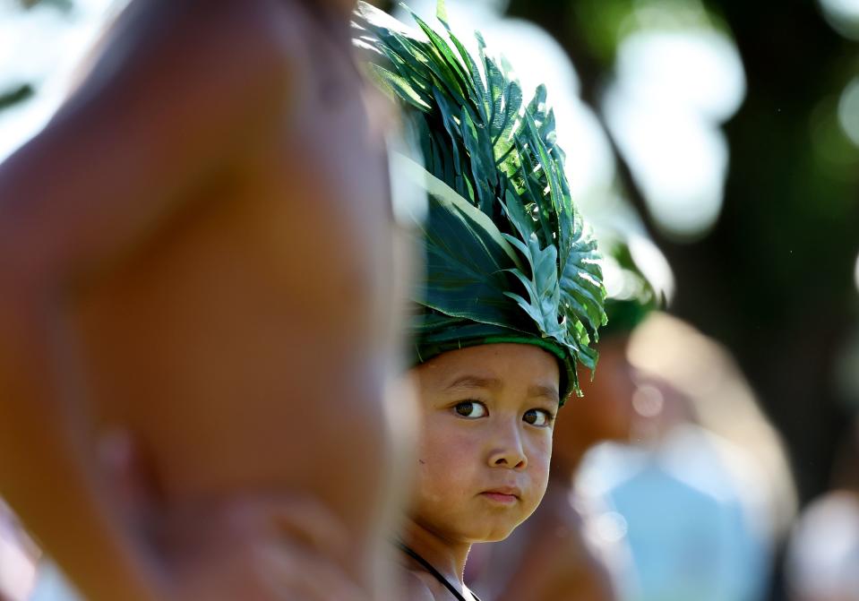 Fire Knife Dancer RJ Taliulu looks over at one of the older dancers just before they begin a dance as their group performs as BYU holds a party to celebrate their move into the Big 12 Conference with music, games and sports exhibits in Provo on Saturday, July 1, 2023. | Scott G Winterton, Deseret News