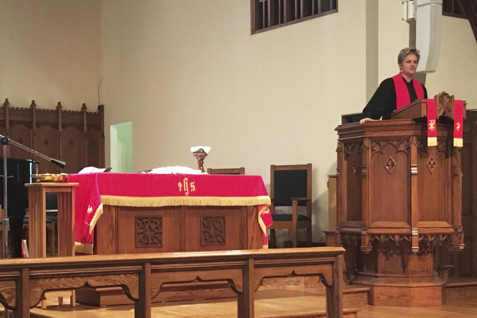 In this photo provided by the Rev. Lucy Robbins, she speaks during a service at the Biltmore United Methodist Church in Asheville, N.C., in October 2018. “Our maintenance costs are just exorbitant,” said the Rev. Lucy Robbins, senior pastor. “And we just don’t have the resources financially that we used to have to be able to do the kind of ministry work that we would like.” (Courtesy Rev. Lucy Robbins via AP)