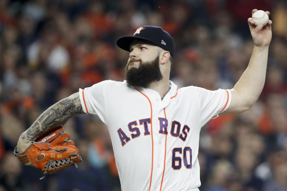 FILE - In this Oct. 16, 2018, file photo, Houston Astros starting pitcher Dallas Keuchel throws against the Boston Red Sox during the first inning in Game 3 of a baseball American League Championship Series in Houston. Keuchel, Bryce Harper, Manny Machado and Craig Kimbrel will not be around when the bat and ball bags are opened at spring training throughout Florida and Arizona this week. They are among the dozens of free agents still looking for jobs. (AP Photo/David J. Phillip, File)