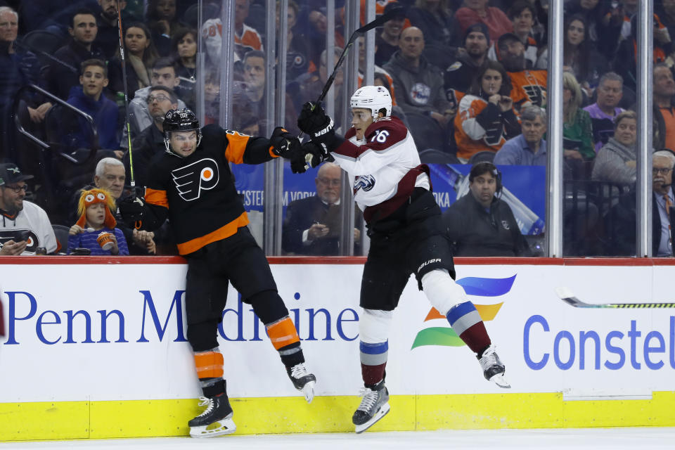 Philadelphia Flyers' Scott Laughton, left, and Colorado Avalanche's Nikita Zadorov collide during the second period of an NHL hockey game, Saturday, Feb. 1, 2020, in Philadelphia. (AP Photo/Matt Slocum)