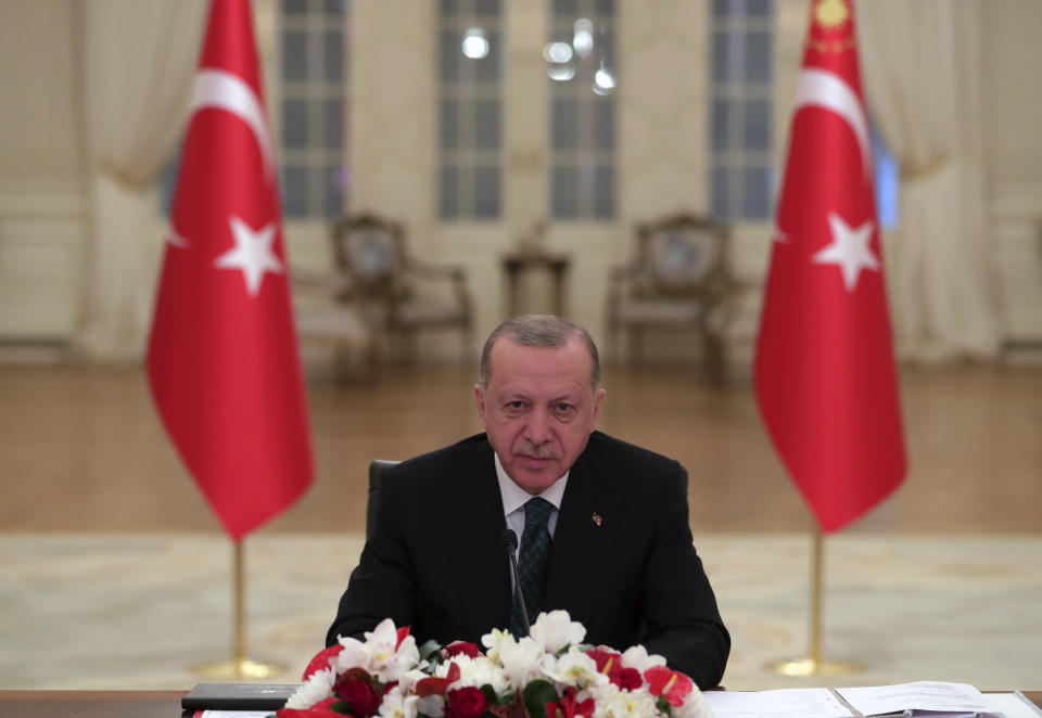 Turkey's President Recep Tayyip Erdogan listens during the opening session of the virtual global Leaders Summit on Climate, as he sits in his office in Ankara, Turkey, Thursday, April 22, 2021. The virtual event attended by many national leaders from their countries around the globe to raise global ambition on climate change is taking place on Earth Day, and hosted by U.S. President Joe Biden. (Mustafa Kamaci/Turkish Presidency via AP)