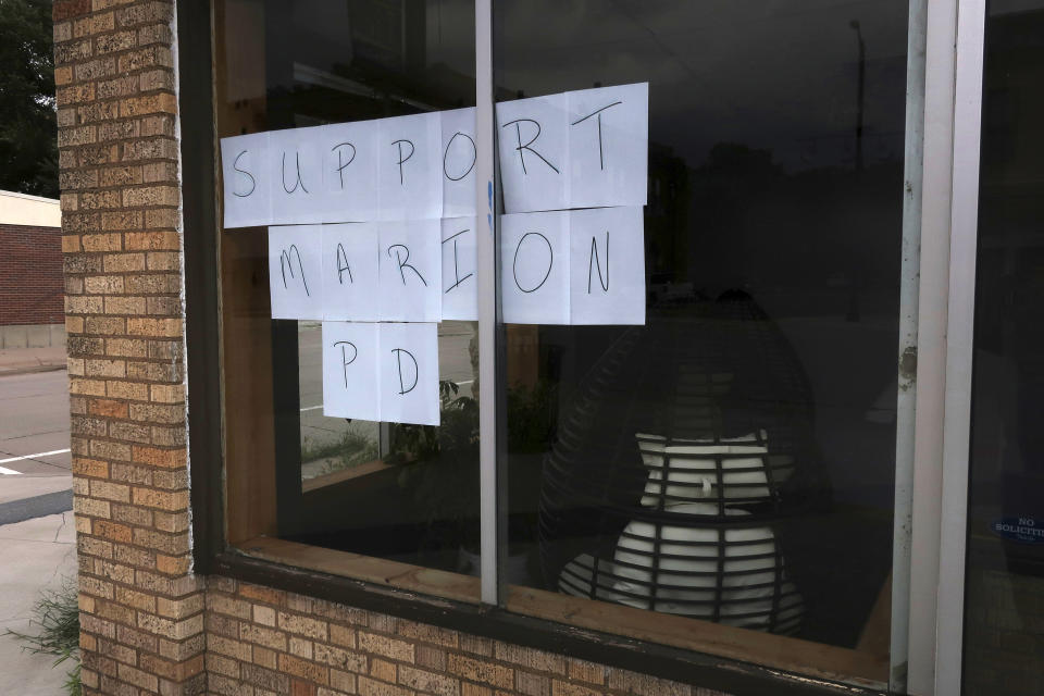 A storefront on the main street in downtown Marion, Kan., features a sign supporting the local police, Sunday, Aug. 13, 2023. The police have faced a torrent of criticism for raiding the offices of the local newspaper and the home of its publisher. (AP Photo/John Hanna)