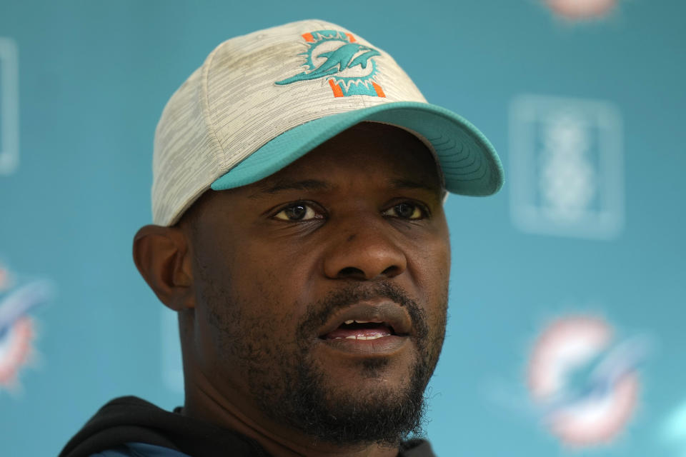 Brian Flores Head Coach of the Miami Dolphins speaks to the press during a practice and media availability by the Miami Dolphins In Ware, England, Friday, Oct. 15, 2021. The Dolphins play the Jaguars in a regular season NFL game on Sunday at Tottenham Hotspurs White Hart Lane stadium in London. (AP Photo/Alastair Grant)