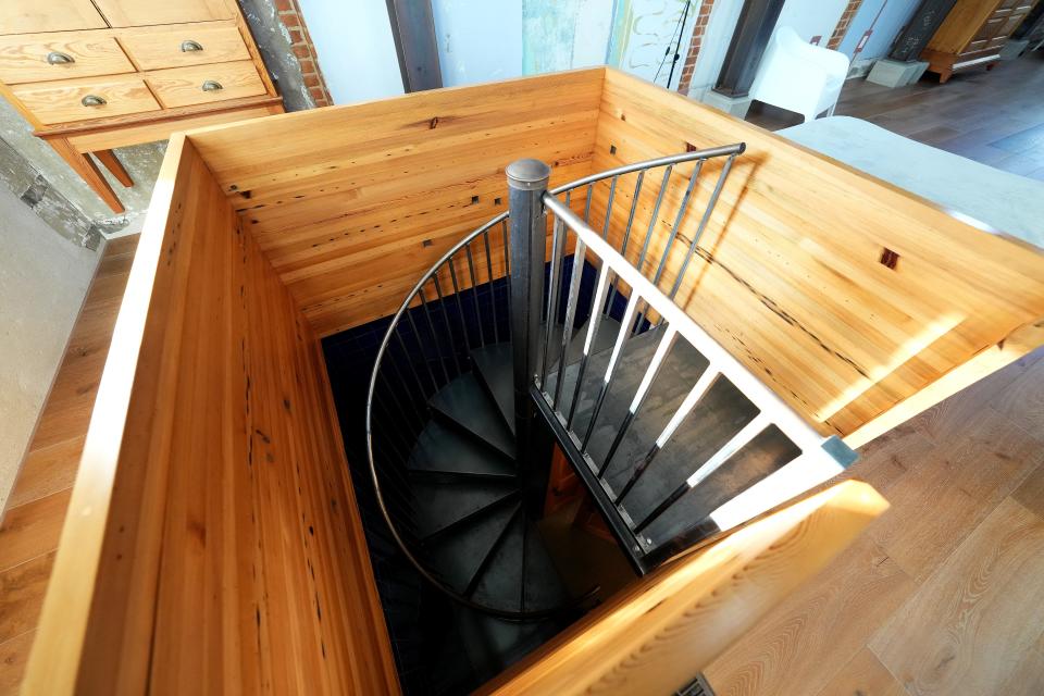 A spiral staircase leads to the basement in the Swing House, which features a large swing hung from the ceiling, in Cincinnati.
