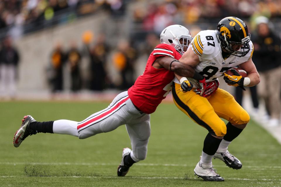 Iowa Hawkeyes tight end Jake Duzey (87) is tackled by Ohio State Buckeyes safety C.J. Barnett (4) during Saturday's game in Columbus, Ohio on Saturday, Oct. 19, 2013. (Jabin Botsford / The Columbus Dispatch)