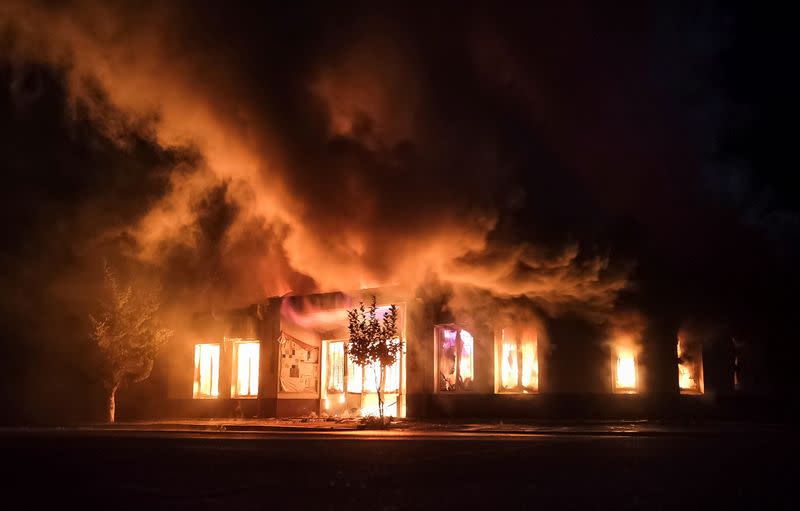 A shop is seen on fire following recent shelling during a military conflict over the breakaway region of Nagorno-Karabakh in Stepanakert