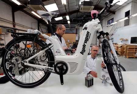 Pierre Forte (R), founder and CEO of Pragma Industries, and Alexandre Blanc (L), operations director, check an Alpha bike, first industrialised bicycle to use a hydrogen fuel cell at the Pragma Industries factory in Biarritz, France, January 15, 2018. REUTERS/Regis Duvignau