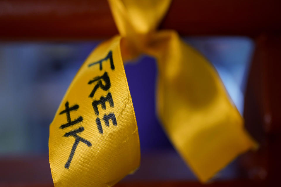 A yellow ribbon written "Free Hong Kong" is displayed at a playhouse, in London, Thursday, May 30, 2024. As the 35th anniversary of Beijing's Tiananmen Square crackdown neared, Rowena He, a prominent scholar of the bloody chapter of modern China, was busy flying between the United States, Britain and Canada to give a series of talks. Each was aimed at speaking out for those who cannot. (AP Photo/Kin Cheung)