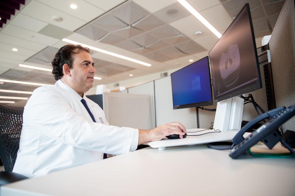 Dr. Victor Ortega looks at a CT scan of a person's lungs inside Mayo Clinic in Phoenix on Aug. 15, 2023.