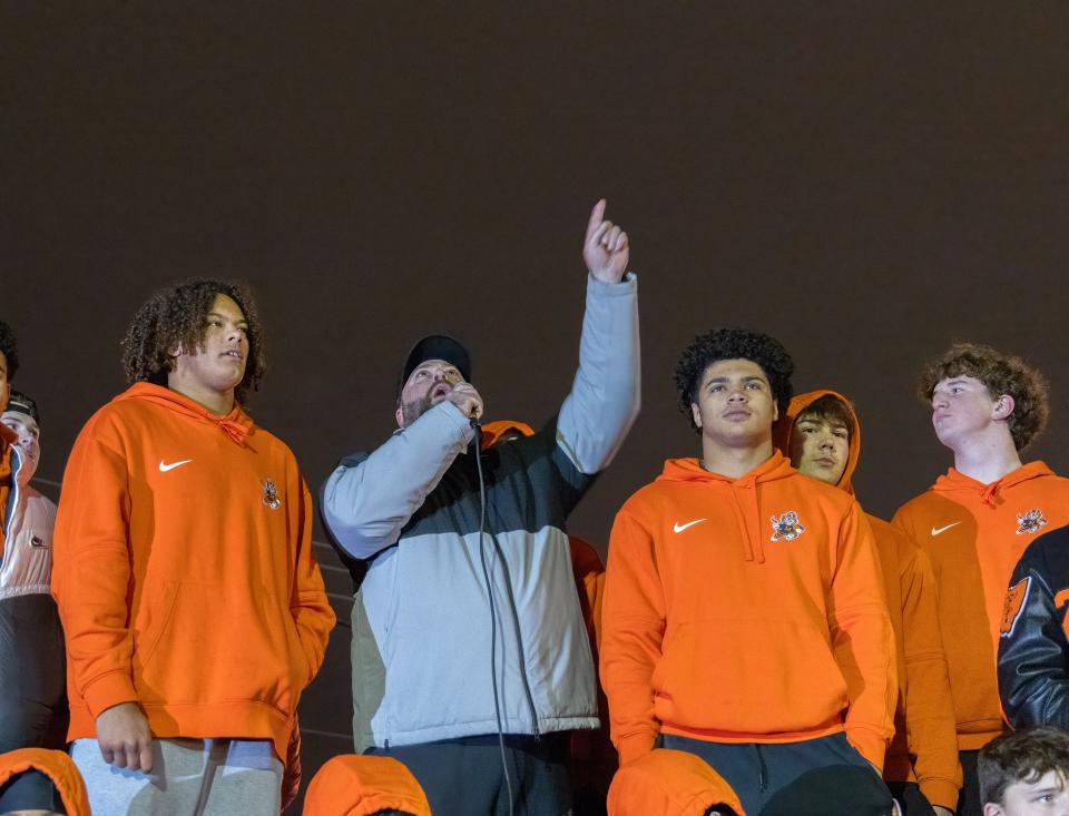 Massillon’s head coach Nate Moore points to the sky and says, “Coach Brown I hope we made you proud this year. Tigers to the grave.”