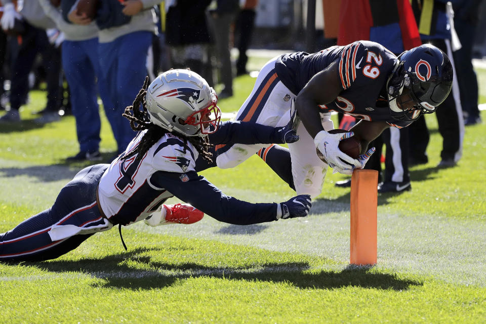 <p>Chicago Bears running back Tarik Cohen (29) dives to the end zone against New England Patriots cornerback Stephon Gilmore (24) for a touchdown during the second half of an NFL football game Sunday, Oct. 21, 2018, in Chicago. (AP Photo/Nam Y. Huh) </p>