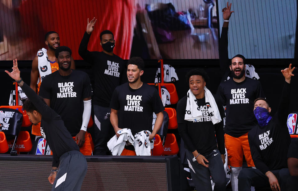 The Phoenix Suns bench reacts after their team scored a three-point basket during the fourth quarter against the Indiana Pacers during an NBA basketball game Thursday, Aug. 6, 2020, in Lake Buena Vista, Fla. (Kevin C. Cox/Pool Photo via AP)