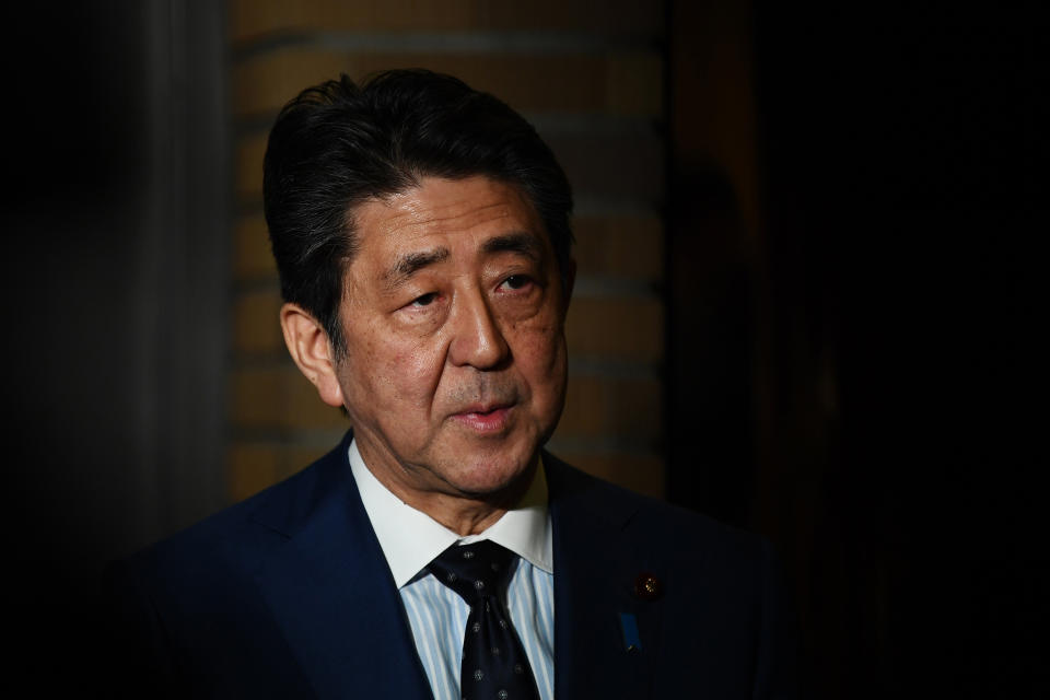 Japan's Prime Minister Shinzo Abe talks to journalists in front of the prime minister's residence in Tokyo, Tuesday, March 24, 2020. Abe says IOC president has agreed "100%" to proposal of postponing Olympics for about 1 year. (Charly Triballeau/Pool Photo via AP)
