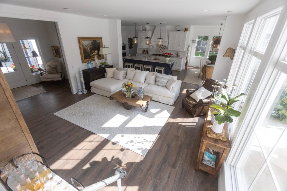 Distressed-look flooring and a palette of white, gray and black are featured in the living area at the modern farmhouse of Michael Kell and Sally Goodnow in Plain Township.