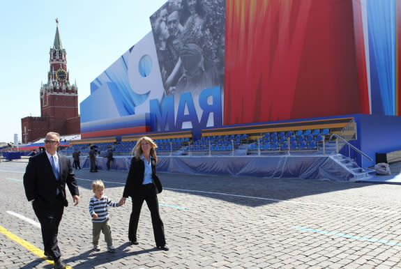 Expedition 36/37 Flight Engineer Karen Nyberg (right) takes a stroll through Red Square in Moscow in front of a grandstand and the Kremlin May 8 with her husband, astronaut Doug Hurley (left) and their 3-year-old son Jack. Nyberg, a NASA astron