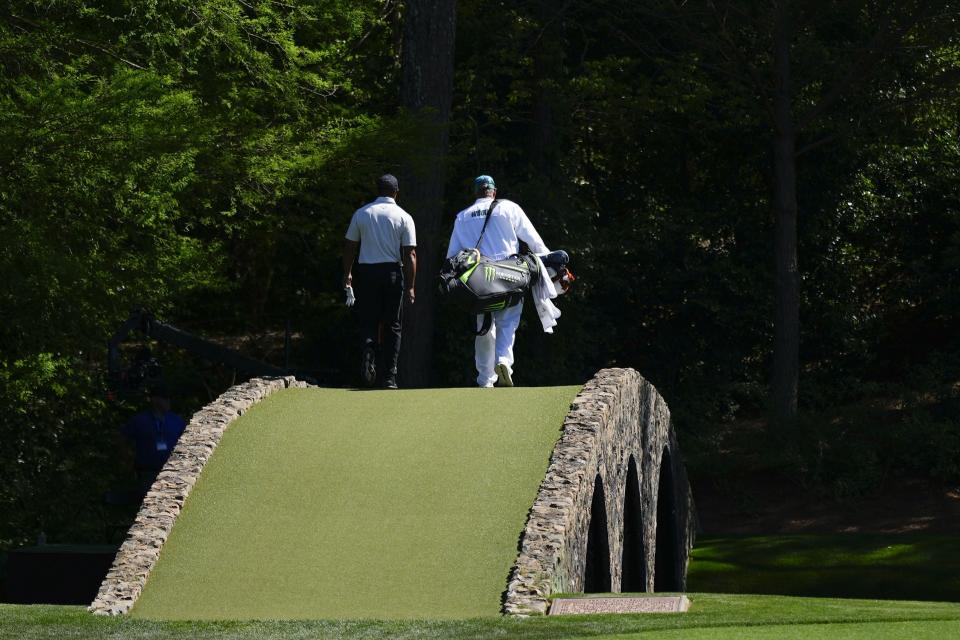 Tiger Woods walks over the Ben Hogan Bridge on the 12th hole during third round at the Masters golf tournament at Augusta National Golf Club Saturday, April 13, 2024, in Augusta, Ga. (AP Photo/Matt Slocum)
