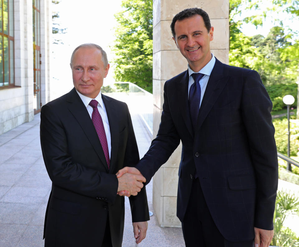 FILE - In this May 17, 2018, file photo, Russian President Vladimir Putin, left, shakes hands with Syrian President Bashar Assad during their meeting in the Black Sea resort of Sochi, Russia. The Russia-Turkey agreement announced on Tuesday, Oct. 22, 2019, said they would jointly patrol almost the entire northeastern Syrian border after the withdrawal of Kurdish fighters, cementing their power in Syria in the wake of Donald Trump’s abrupt withdrawal of U.S. forces. (Mikhail Klimentyev, Sputnik, Kremlin Pool Photo via AP, File)