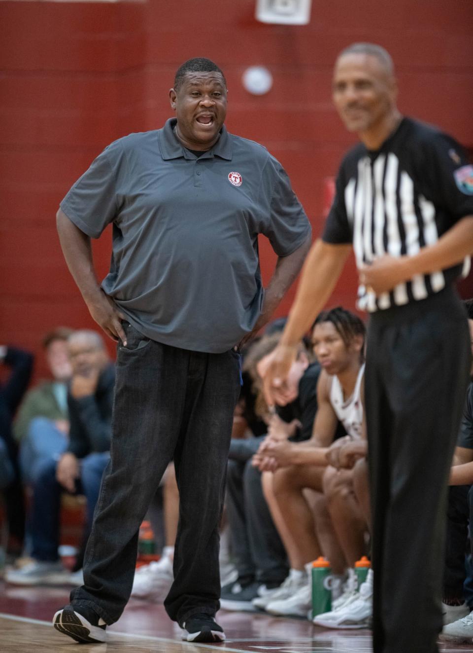 Aggies head coach Clyde Abney questions a call during the Navarre vs Tate boys basketball game at Tate High School on Friday, Jan. 12, 2024.