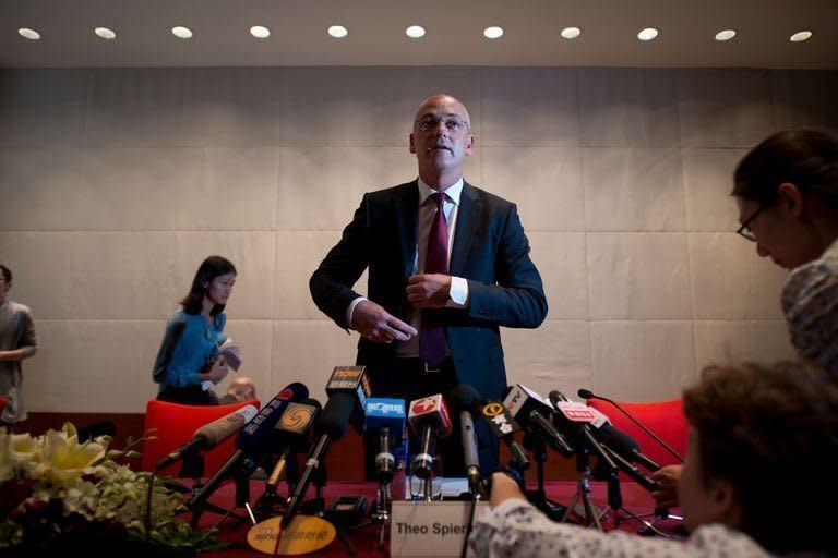 Theo Spierings (C), CEO of New Zealand dairy giant Fonterra, arrives for a press conference in Beijing on August 5, 2013. Spierings apologised Monday for a botulism scare that saw product recalls and seizures from China to Saudi Arabia, but denied accusations it delayed releasing information