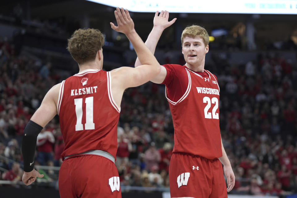 Wisconsin guard Max Klesmit (11) and forward Steven Crowl (22) high-five during the first half of an NCAA college basketball game against Purdue in the semifinal round of the Big Ten Conference tournament, Saturday, March 16, 2024, in Minneapolis. (AP Photo/Abbie Parr)