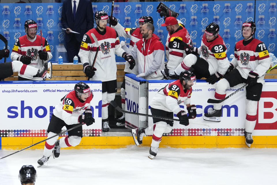 Austria's players celebrate after the preliminary round match between Norway and Austria at the Ice Hockey World Championships in Prague, Czech Republic, Sunday, May 19, 2024. (AP Photo/Petr David Josek)