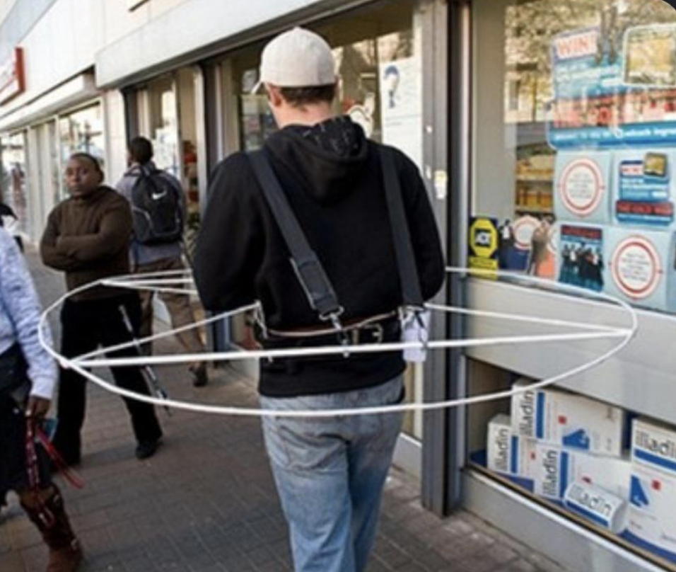 a man with a device to make sure no one comes near him