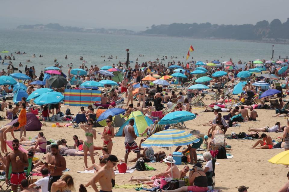 Bournemouth: Hundreds of people at the beach in Bournemouth, as the UK could encounter the hottest July day on record (PA)