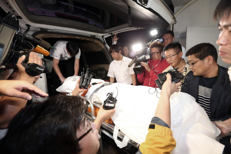 The body of a man believed to be the fugitive owner of the sunken ferry Sewol is carried into an ambulance at a funeral hall in Suncheon, South Korea, Tuesday, July 22, 2014. South Korean police said Tuesday that they have found the body of a fugitive billionaire businessman sought over April&#39;s ferry disaster that left more than 300 people dead or missing.(AP Photo/Yonhap, Park Chul-hong) KOREA OUT