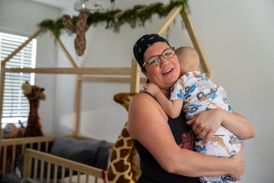 Charity hugs 3-year-old son Tobias, who is battling leukemia.