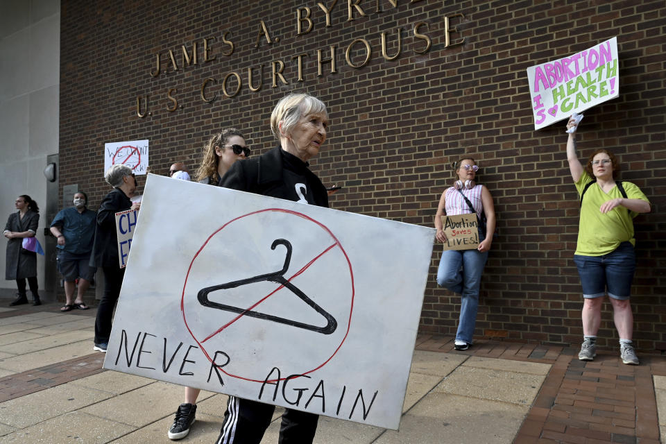 Women gather with signs during an abortion rights demonstration outside the federal courthouse in Philadelphia on Tuesday. (Tom Gralish/The Philadelphia Inquirer via AP)